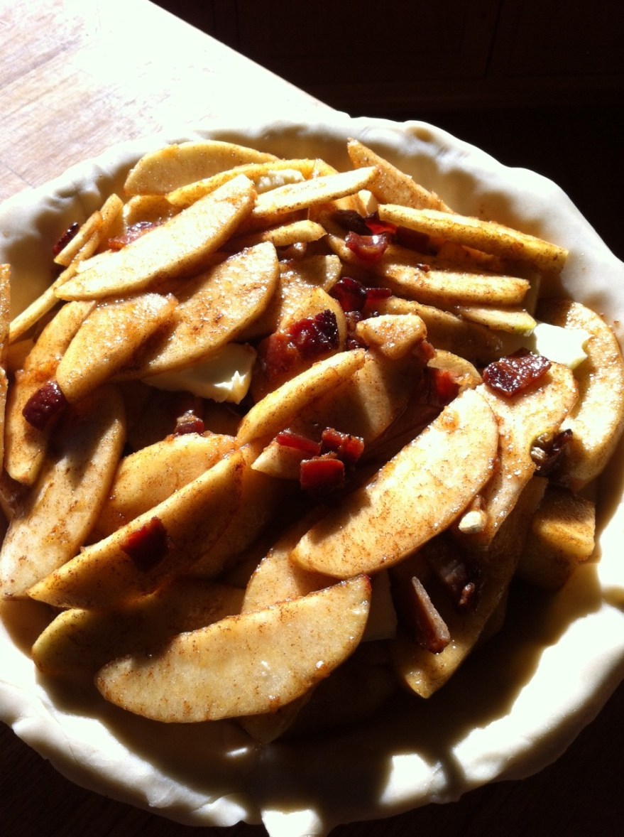 Strategically stack the apples in your pie dish in layers 1/3 at a time, sprinkling bacon on each layer and then adding a couple pats of butter.